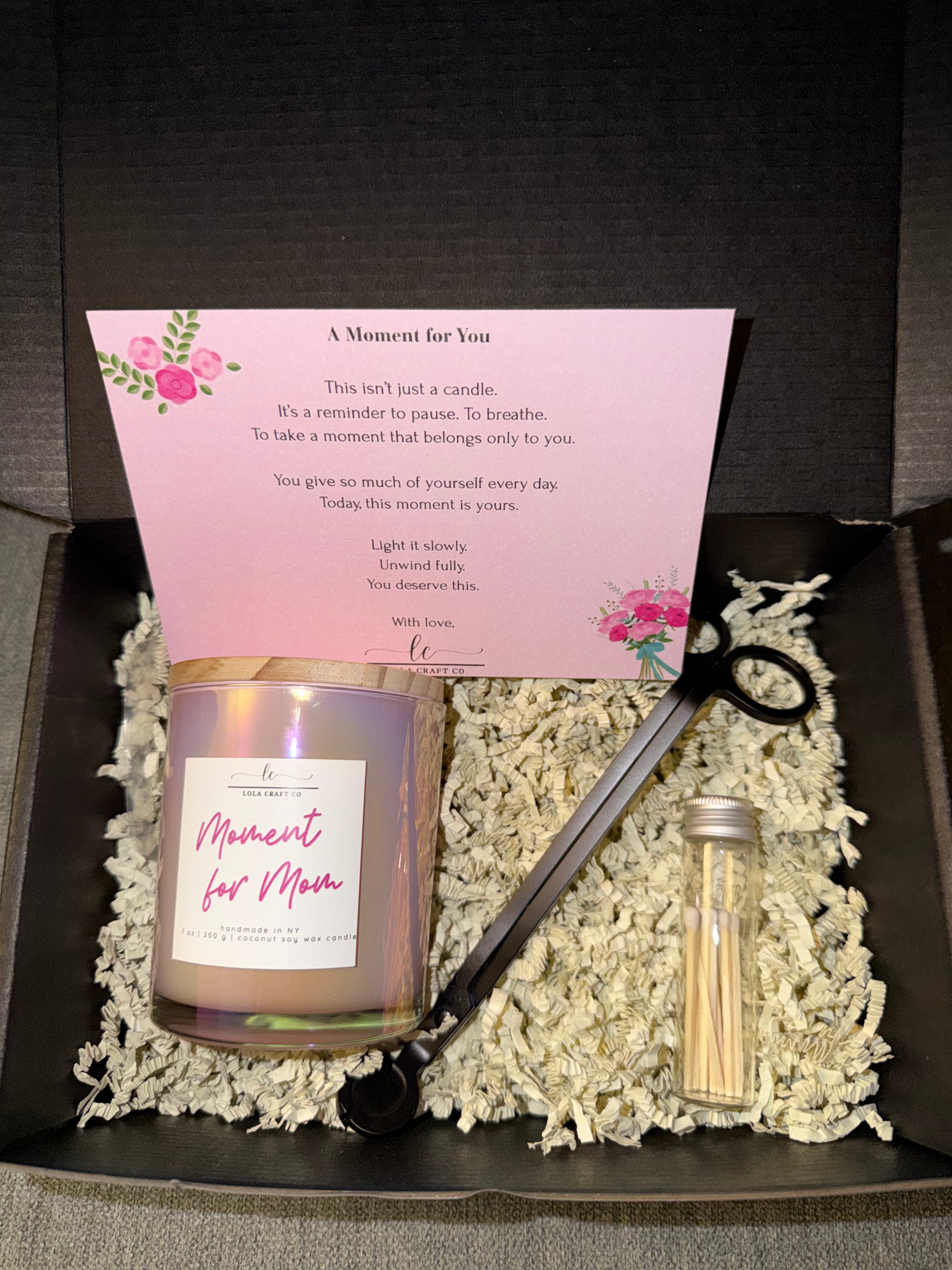 Candle with a card, wick trimmers, and matches in a box